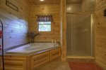 Main Floor Bathroom with a Walk- In Shower and Jetted Garden Tub 